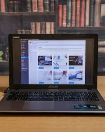 black laptop computer on brown wooden table