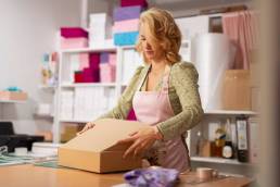 woman packing product for online store shipping